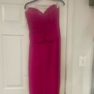 100% pink strapless evening gown with diamond cut out in the front. Prom perfect